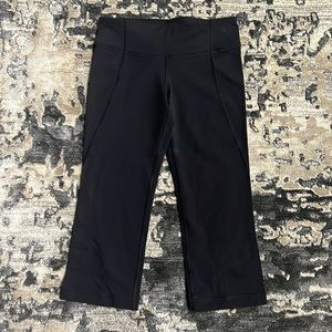 Lululemon black capri with slit in back of legs.